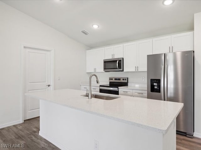 kitchen featuring appliances with stainless steel finishes, a center island with sink, and white cabinets