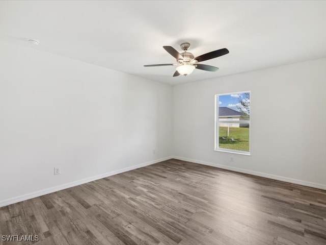 unfurnished room featuring dark hardwood / wood-style floors and ceiling fan