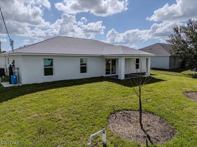 back of property featuring a lawn