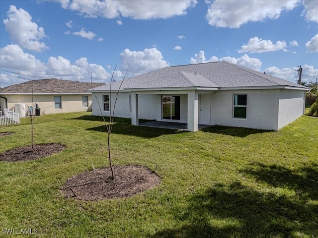 back of house featuring a yard