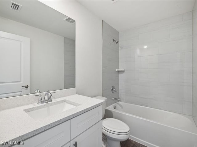 full bathroom with vanity, toilet, and tiled shower / bath