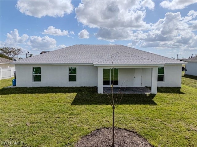 rear view of house with a lawn