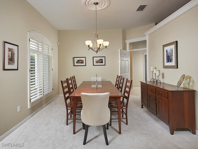 carpeted dining space with a chandelier