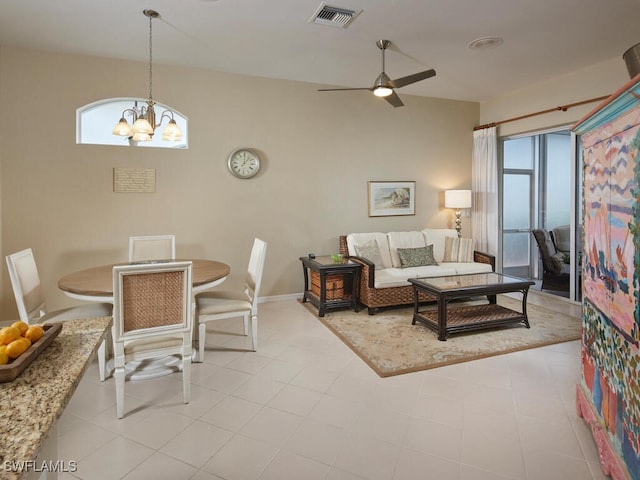 living room featuring ceiling fan with notable chandelier