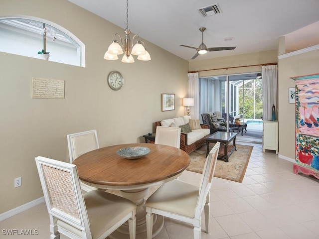 dining room featuring ceiling fan with notable chandelier and light tile patterned floors