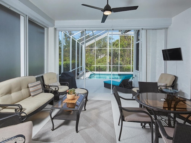 sunroom featuring ceiling fan and a pool