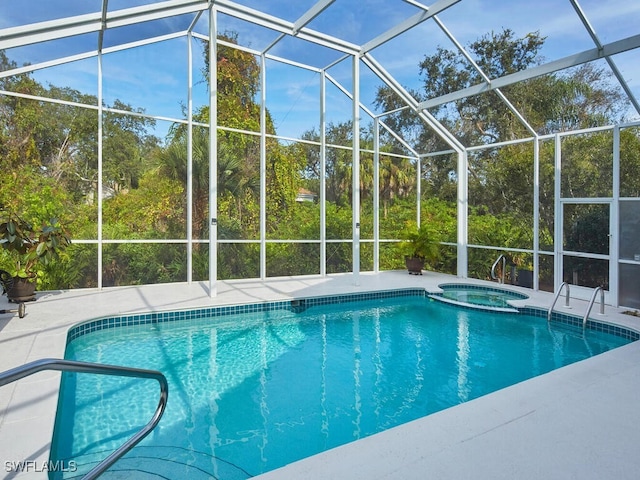 view of swimming pool with a lanai, a patio area, and an in ground hot tub