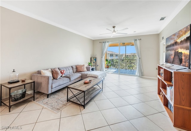 tiled living room with ceiling fan and crown molding