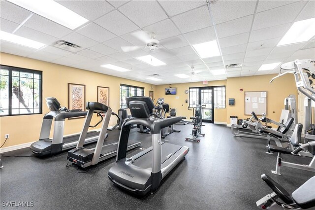 workout area featuring a drop ceiling and ceiling fan