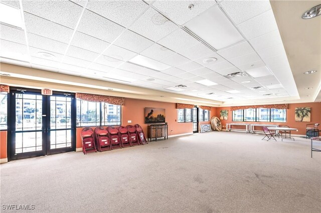 misc room with carpet, a drop ceiling, and plenty of natural light