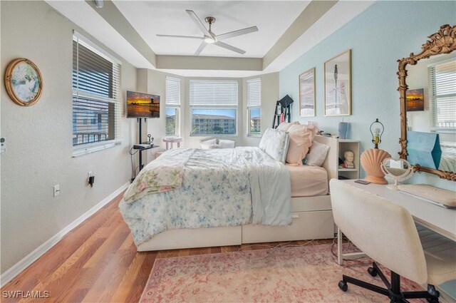 bedroom with light hardwood / wood-style flooring and ceiling fan