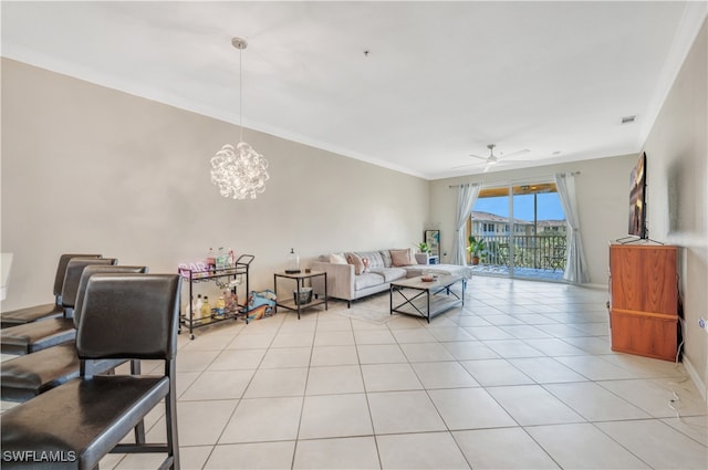 tiled living room featuring crown molding and ceiling fan with notable chandelier