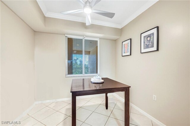 unfurnished office featuring ceiling fan, ornamental molding, and light tile patterned floors