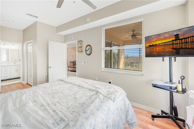 bedroom with connected bathroom, light hardwood / wood-style flooring, and ceiling fan