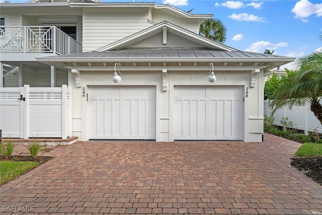 view of front of home featuring a balcony and a garage