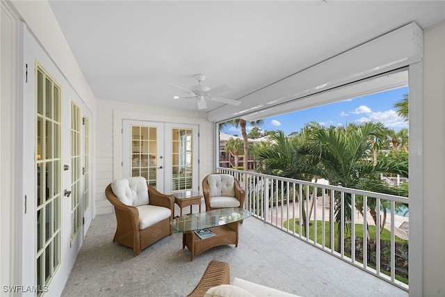 sunroom / solarium with ceiling fan and french doors