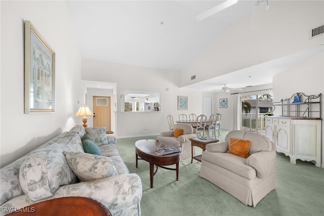 living room with carpet floors, high vaulted ceiling, and ceiling fan