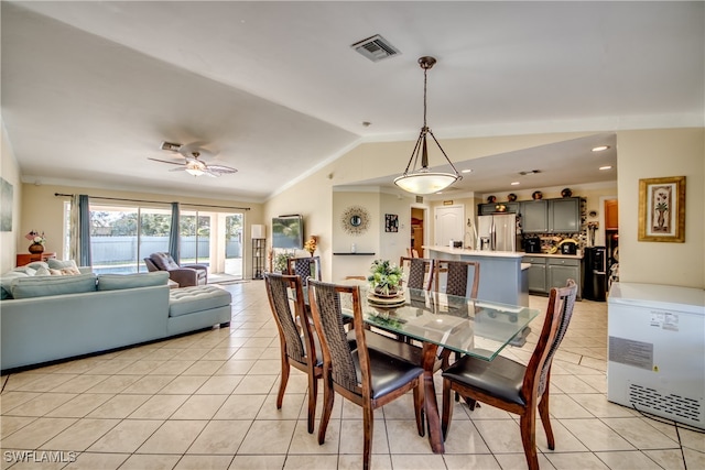 dining area with ceiling fan, light tile patterned flooring, lofted ceiling, and crown molding