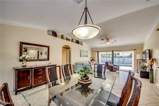 tiled dining area with vaulted ceiling and ceiling fan