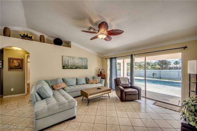 tiled living room featuring ceiling fan and lofted ceiling