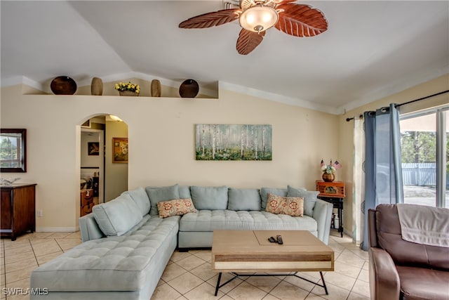 tiled living room with ceiling fan and lofted ceiling