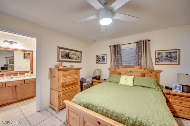 bedroom with ensuite bathroom, ceiling fan, light tile patterned floors, and sink