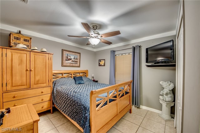 tiled bedroom featuring ceiling fan