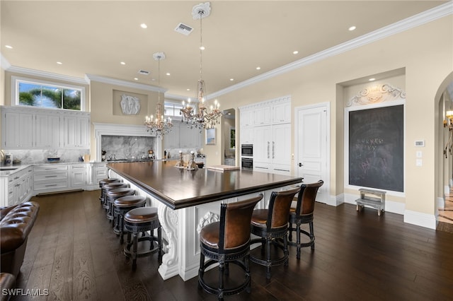 kitchen with a center island, white cabinets, and dark hardwood / wood-style floors