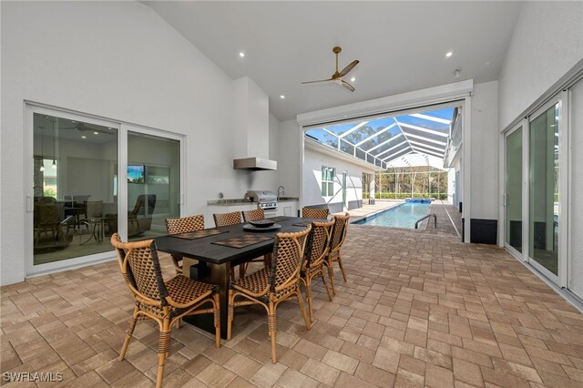 dining room with ceiling fan and high vaulted ceiling