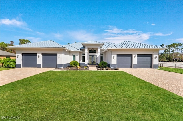 view of front of home featuring a front lawn and a garage