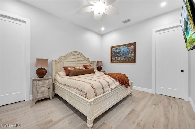 bedroom with light hardwood / wood-style floors and ceiling fan