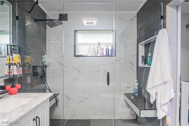 bathroom featuring vanity, ornamental molding, and a shower with shower door