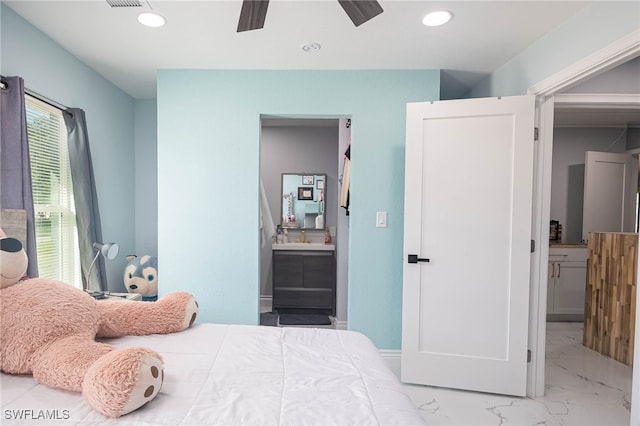 bedroom featuring ensuite bath and ceiling fan