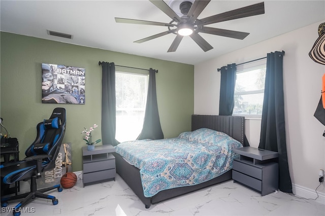 bedroom featuring multiple windows and ceiling fan