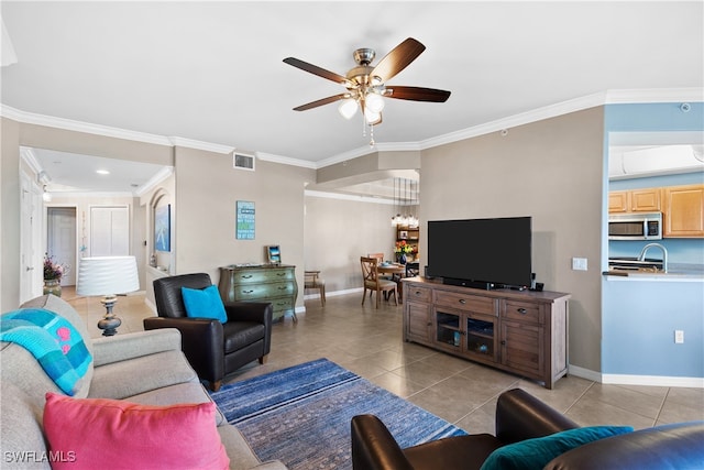 living room with crown molding, light tile patterned floors, and ceiling fan