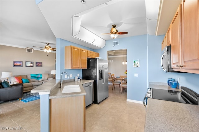 kitchen with light brown cabinetry, appliances with stainless steel finishes, sink, and light tile patterned floors