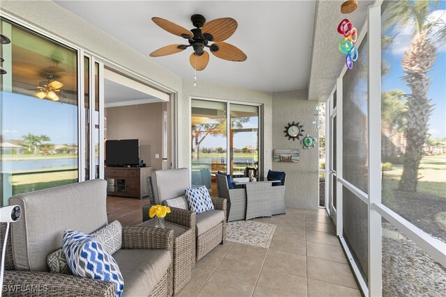 sunroom / solarium featuring ceiling fan