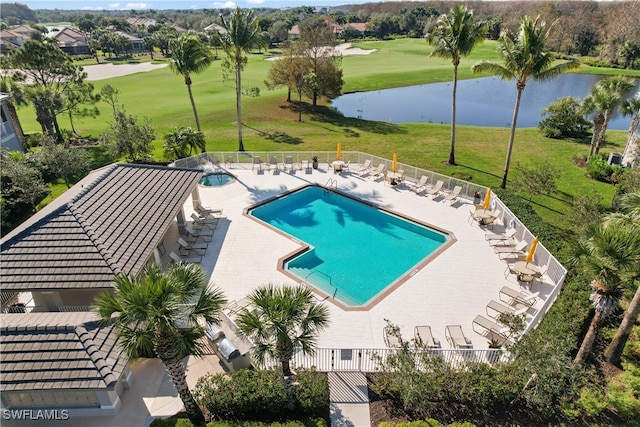 view of swimming pool with a patio, a yard, and a water view