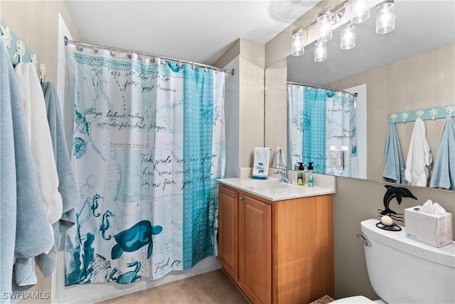 bathroom featuring toilet, curtained shower, vanity, and tile patterned floors