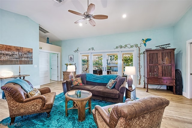 living room with lofted ceiling, french doors, light wood-type flooring, and ceiling fan