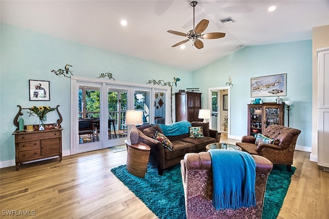 living room featuring french doors, ceiling fan, light wood-type flooring, and vaulted ceiling