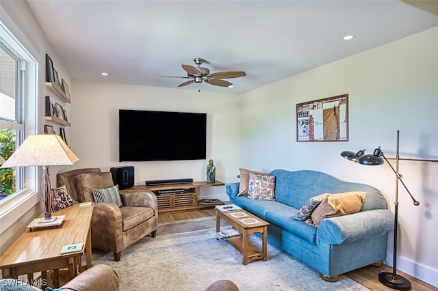 living room with ceiling fan and light wood-type flooring