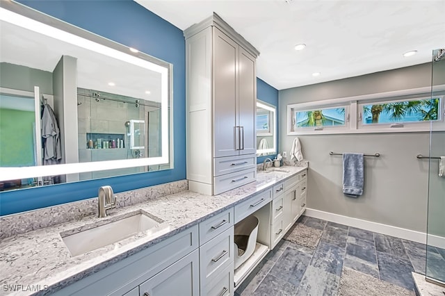 bathroom featuring vanity, plenty of natural light, and walk in shower