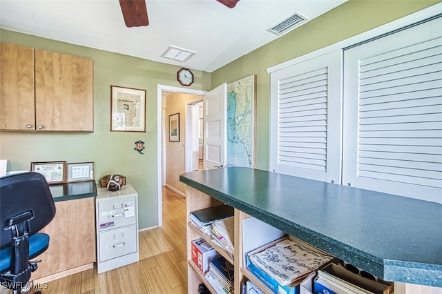 office space with light hardwood / wood-style flooring and ceiling fan