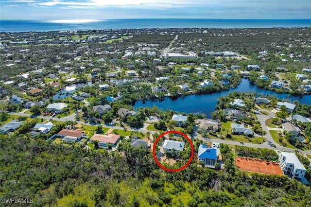 birds eye view of property with a water view