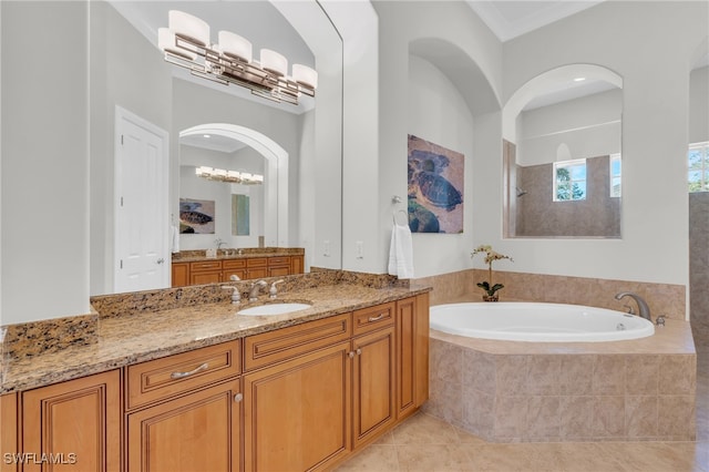 bathroom featuring vanity, ornamental molding, tile patterned floors, and tiled bath