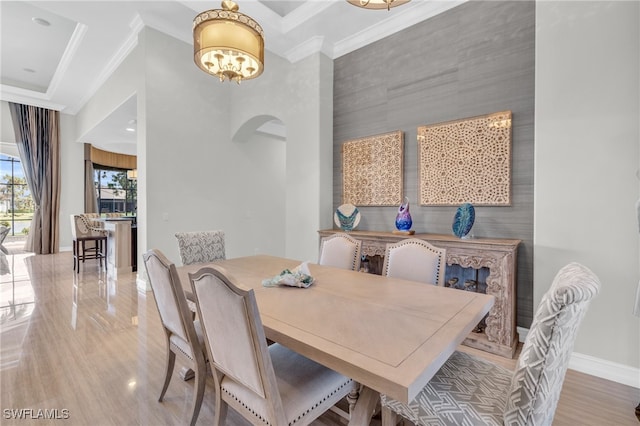 dining space featuring crown molding and wood-type flooring