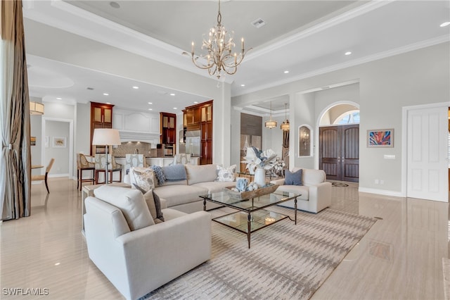 living room with ornamental molding and a chandelier