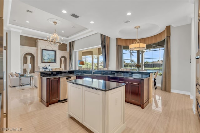 kitchen featuring a center island, a raised ceiling, dishwasher, and hanging light fixtures