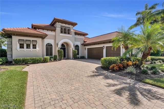 mediterranean / spanish-style house featuring a garage